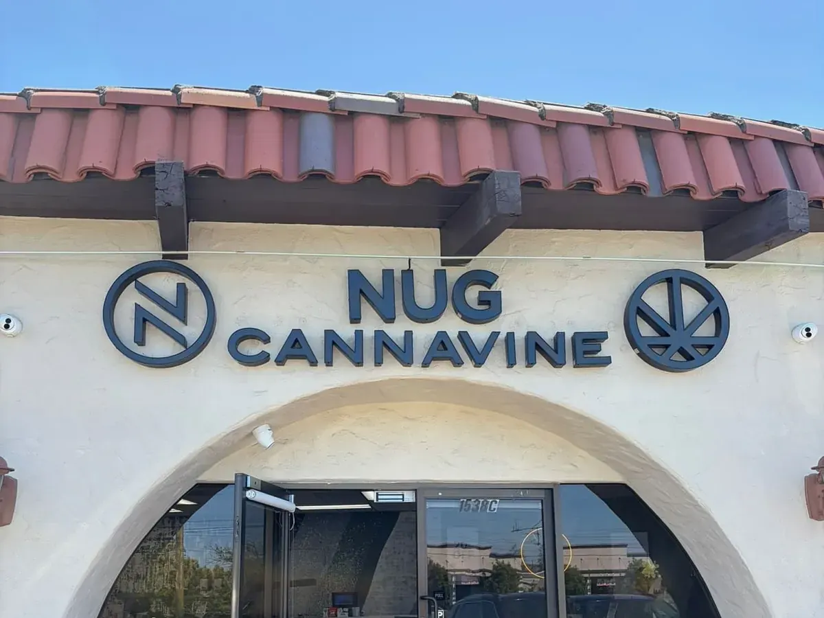 Nug Cannavine storefront with tiled roof, arched entrance, and blue signage